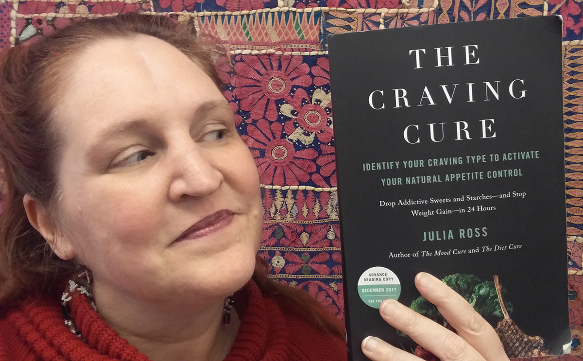 Carma holding a copy of The Craving Cure by Julia Ross